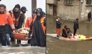 Palestinian rescuers evacuate camp residents from flooded houses