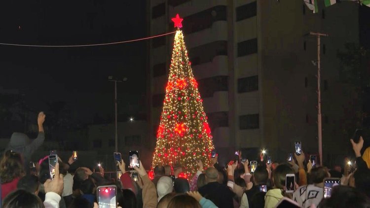 Palestinians celebrate lighting of Christmas tree in Gaza