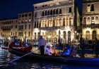 Olympic flame sails through Venice